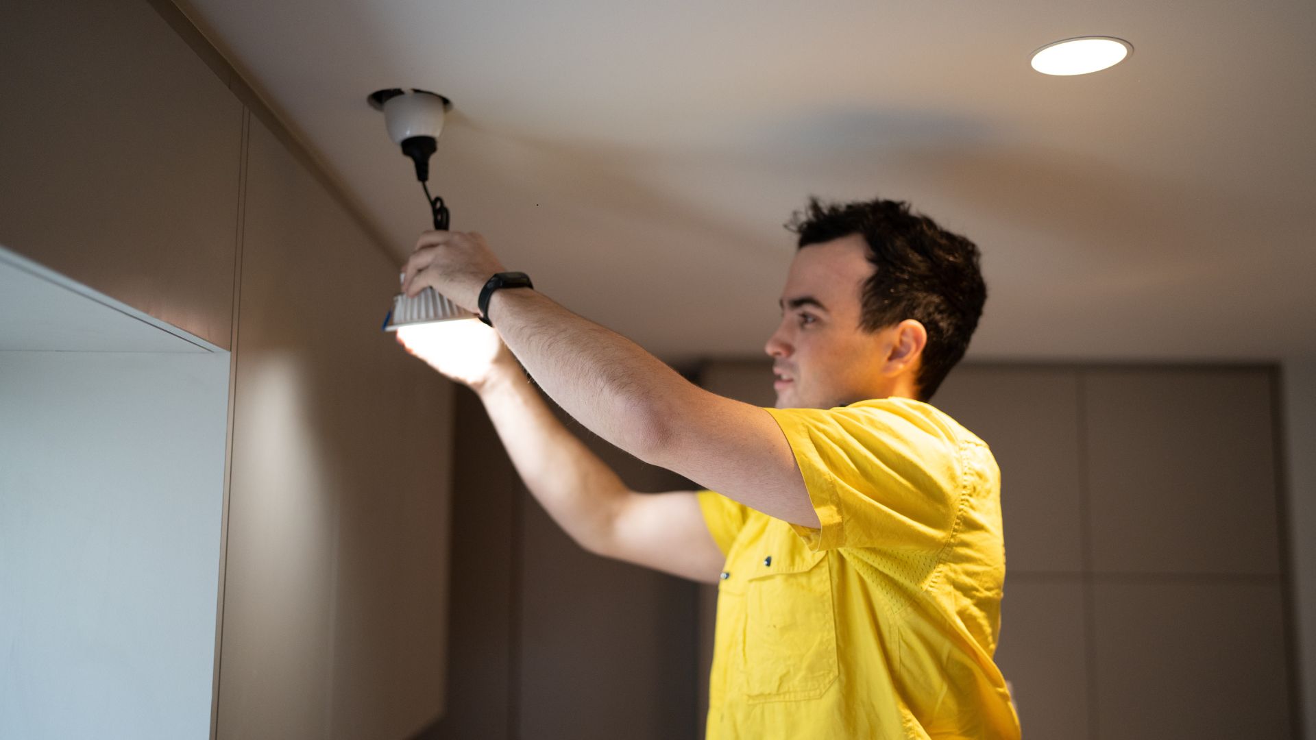 wollongong electrician installing a overhead LED light