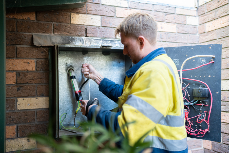Renovation electrician working on a residential switchboard.